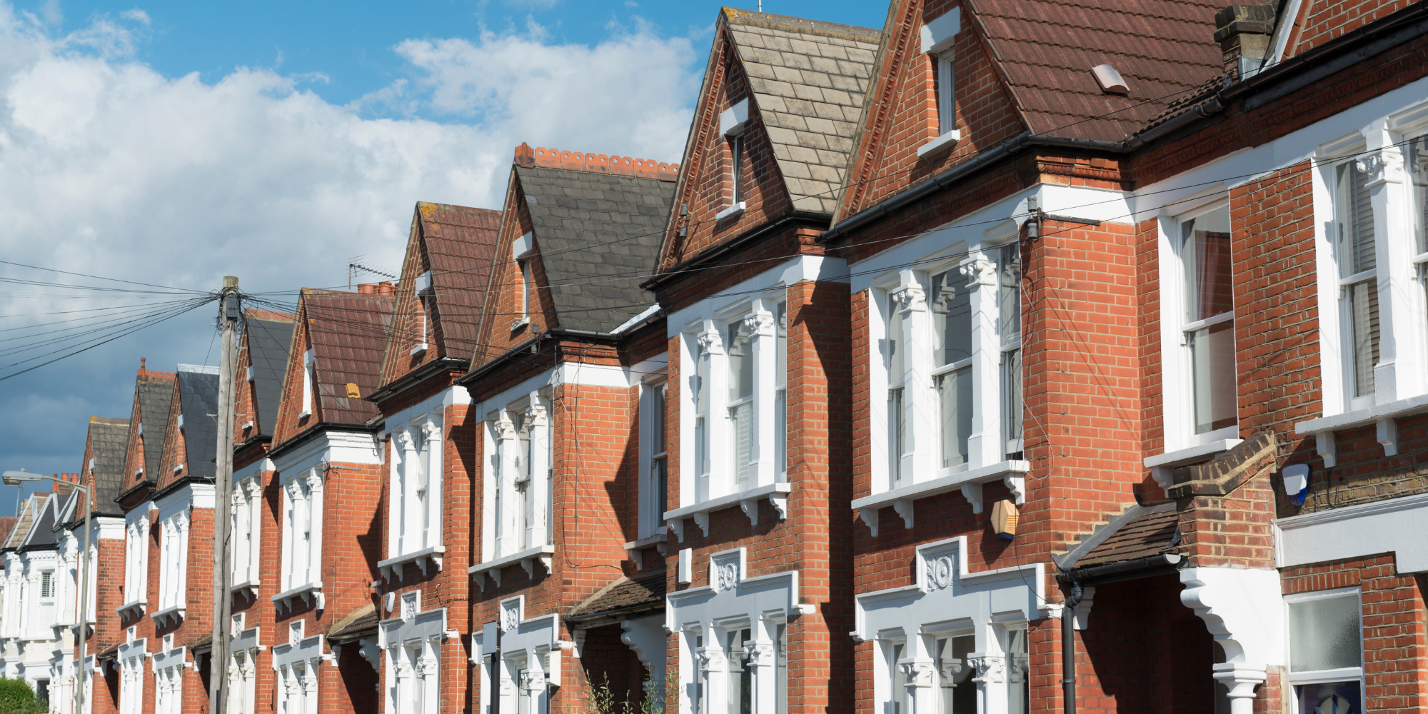 Orange houses with white windows.